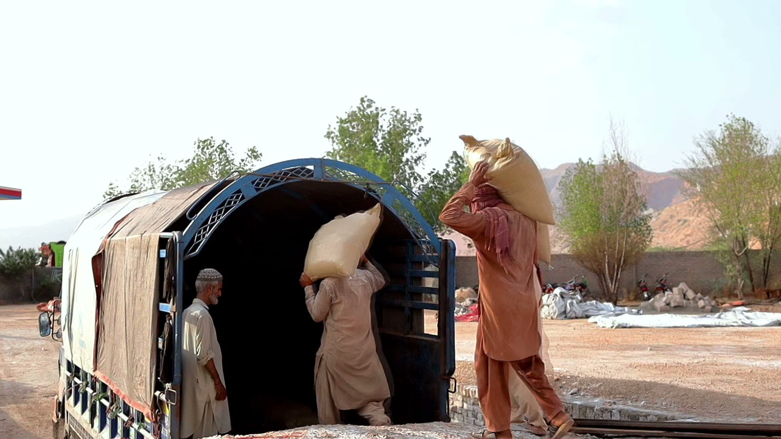 Workers loading palletized salt sacks onto a truck at the Himalac warehouse